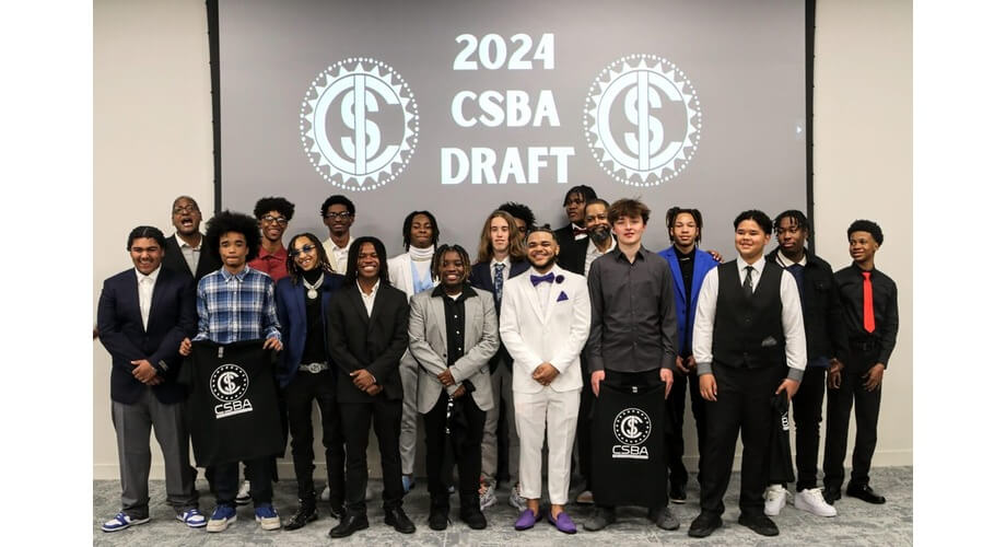 2024 CSBA Draft Event with Young Athletes Diverse young male athletes and adults celebrating at the 2024 CSBA Draft event. Two hold CSBA branded t-shirts.