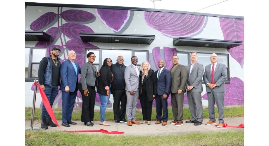 Connector Building Grand Opening with Community Leaders Community leaders celebrate the Connector building's grand opening, featuring a vibrant purple leaf mural and ribbon-cutting.