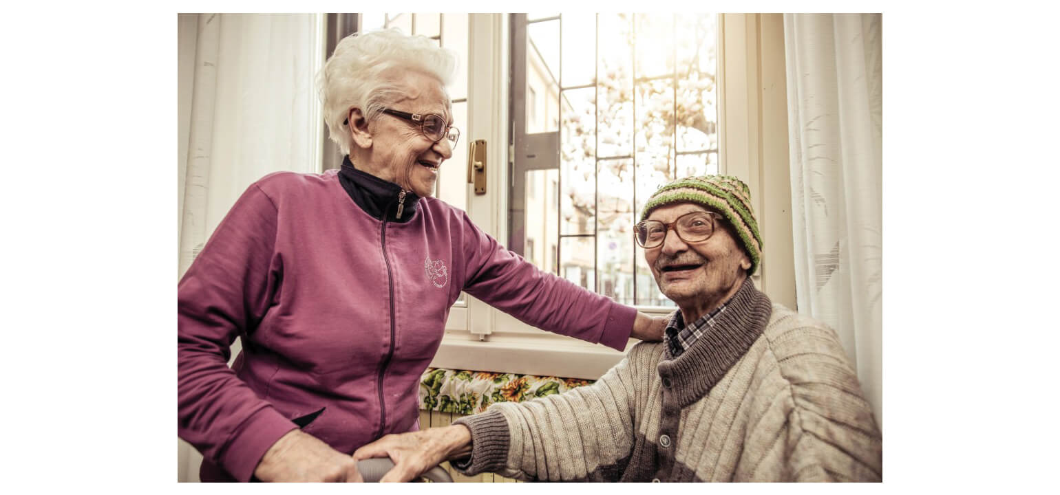 Happy elderly couple smiling indoors, showcasing companionship and WIFIAN's commitment to senior well-being.