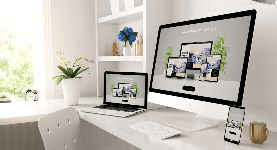 A responsive web design for a travel website displayed across desktop, laptop, and mobile screens.