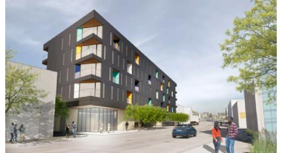 Modern Residential Building with Colorful Windows Contemporary multi-story residential building with dark facade, bright colorful windows, balconies, and a street scene.