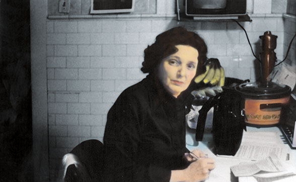 Young Helen Daniels Bader diligently studying botany at a kitchen table, surrounded by papers and appliances.