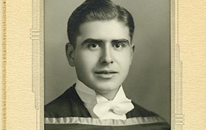 Handsome young man in academic regalia, vintage black and white graduation portrait from the 1930s.