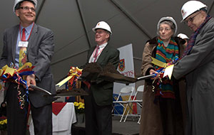 Four people in hard hats celebrate a groundbreaking ceremony for the Isabel project, circa 1998.