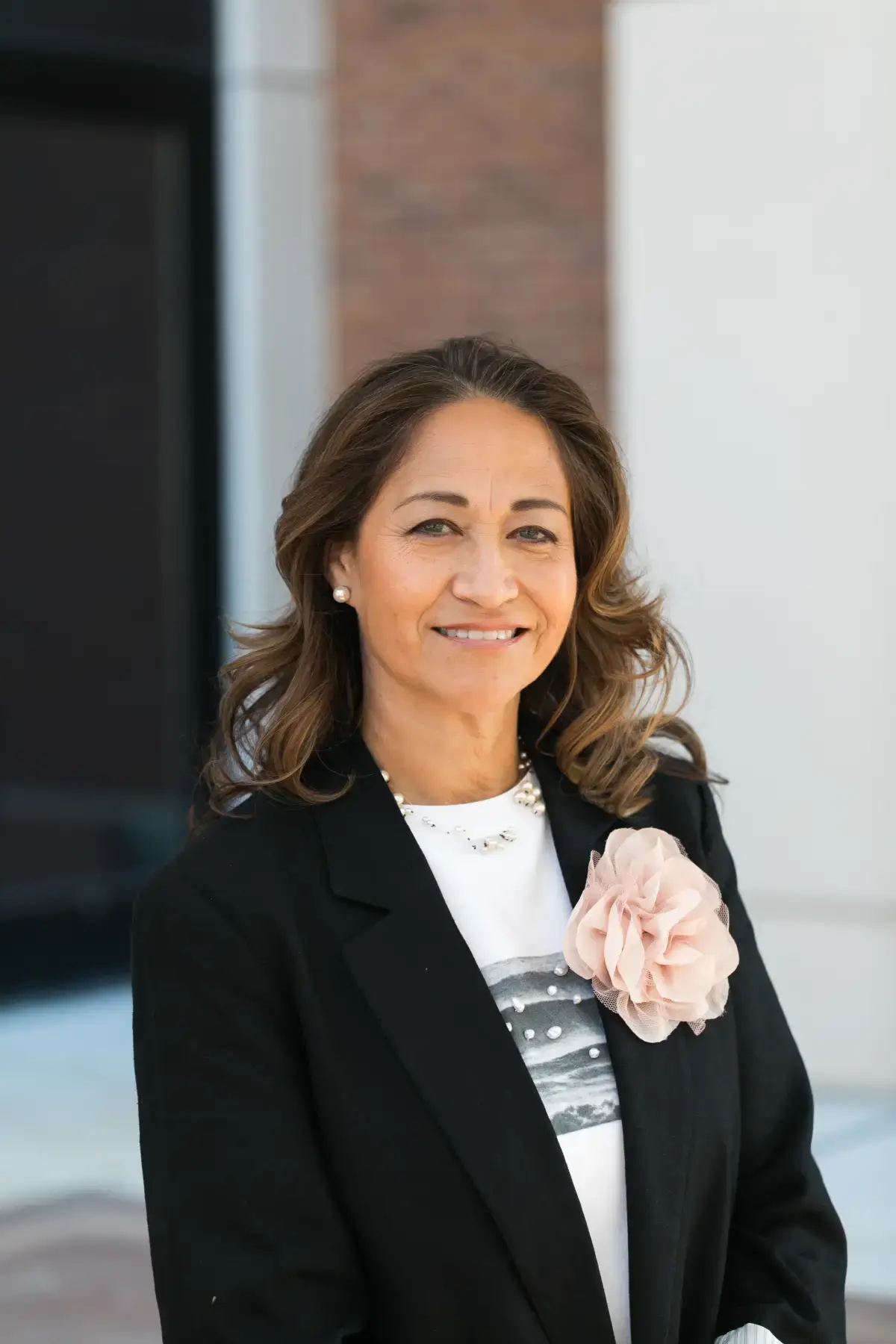 Maria L. Vento, MBA, professional business headshot. She smiles warmly, wearing a black blazer, white top, and pearl necklace.