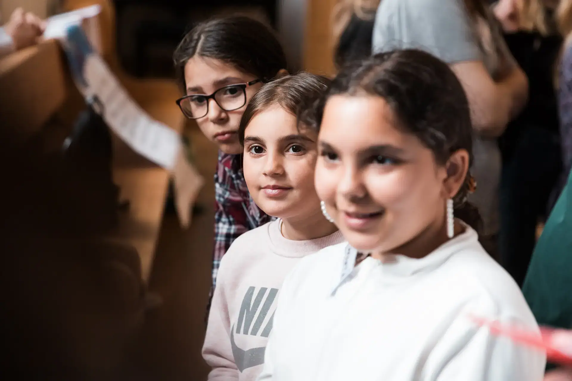 Three diverse young girls focused and engaged during a CEDU Social Equality program. Empowering youth education.