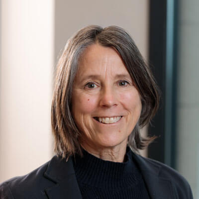 Graham Andersong in a red Milwaukee jacket and checkered shirt, looking professional against a white background.