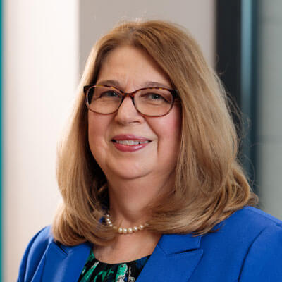 Headshot of Miriam Horowitz. Woman with short hair wearing glasses. 
