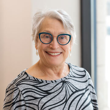 Headshot of Miriam Horowitz. Woman with short hair wearing glasses. 