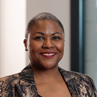 Nick Davis, smiling man in blue polo shirt, glasses, and goatee. Professional headshot.