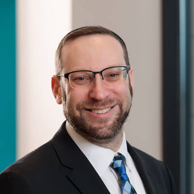 Shary Tran smiling professional headshot, dark hair, navy top, black blazer.