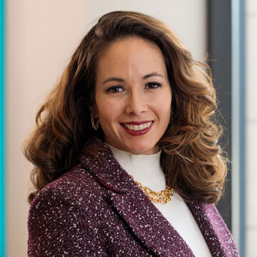 Headshot of Samantha Maldonado. Woman with long curly hair.