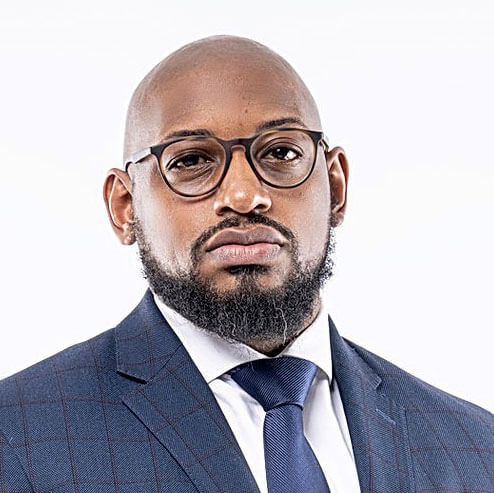 Shary Tran smiling professional headshot, dark hair, navy top, black blazer.